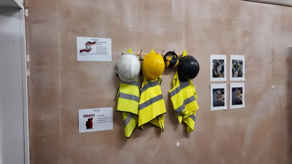 Construction safety gear used in vocational SEND training including helmets and high visibility jackets