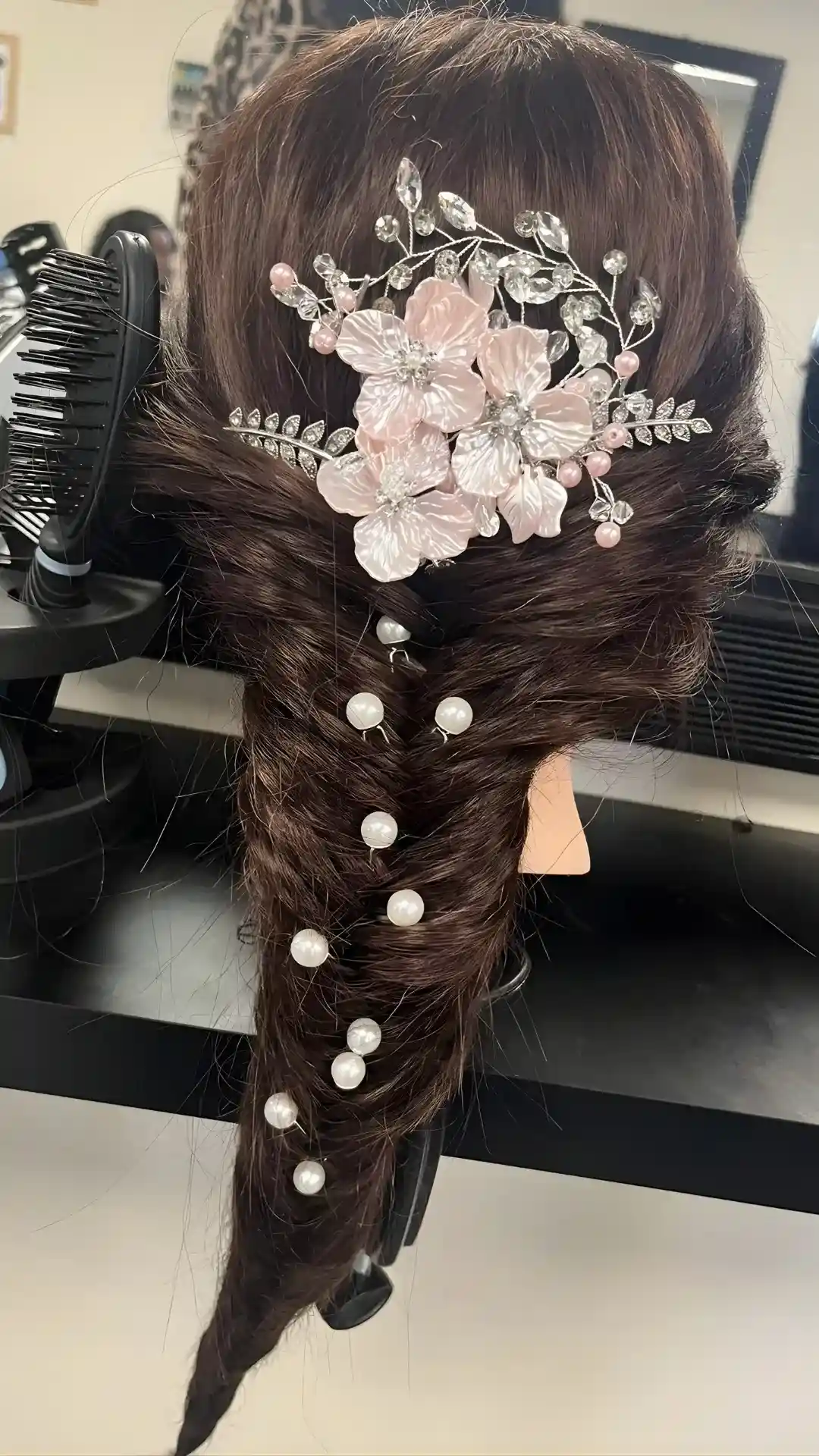 Hairdressing practice work in vocational SEND training showing styled hair with accessories